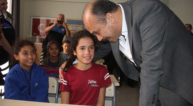 Öğrencileri elleriyle giydirdi