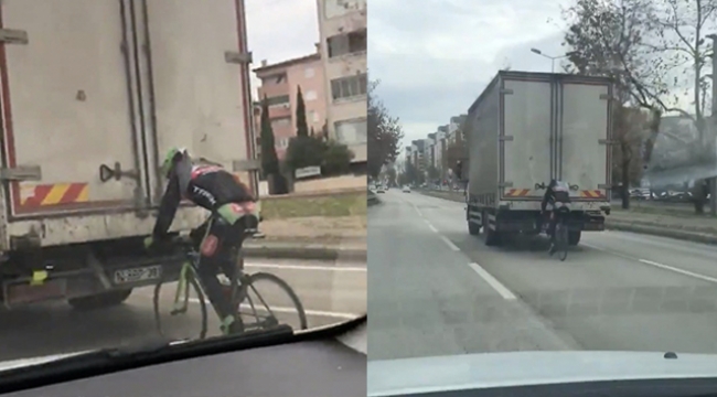 Bisikleti üzerinde canını hiçe sayarak yolculuk etti