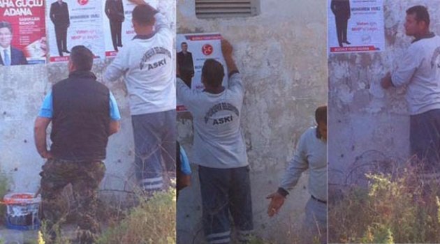 ASKİ ekipleri MHP’nin afişlerini asıyor