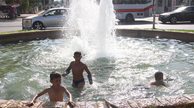 Çocuklar süs havuzunda serinliyor